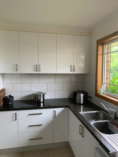 Black maelamine bench top with white melamine covered cabinets